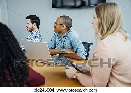 Business people listening in meeting View Large Photo Image Picture - Business people listening in meeting. Fotosearch