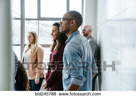 Business people near whiteboard View Large Photo Image Stock Photo - Business people near whiteboard. Fotosearch