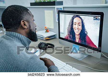 Business people on video conference View Large Photo Image Stock Image - Business people on video conference. Fotosearch
