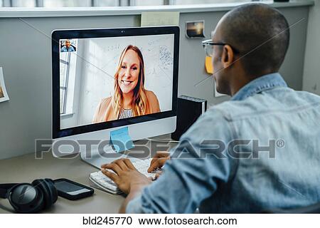 Business people on video conference View Large Photo Image Stock Image - Business people on video conference. Fotosearch