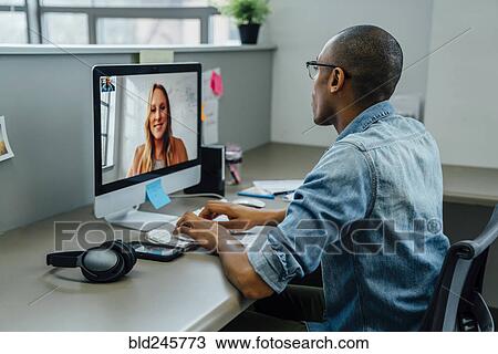 Business people on video conference View Large Photo Image Stock Image - Business people on video conference. Fotosearch