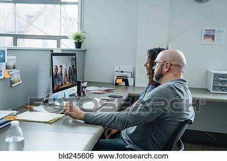 Stock Photograph - Business people on video conference. Fotosearch