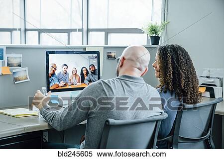 Business people on video conference View Large Photo Image Stock Photography - Business people on video conference. Fotosearch