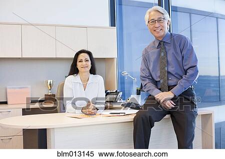 Stock Photography - Business people sitting together in office. Fotosearch
