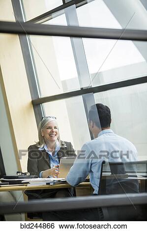 Business people smiling in meeting View Large Photo Image Stock Photograph - Business people smiling in meeting. Fotosearch