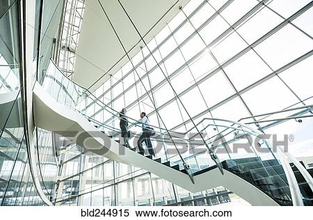 Business people standing on staircase and talking View Large Photo Image Stock Photography - Business people standing on staircase and talking. Fotosearch