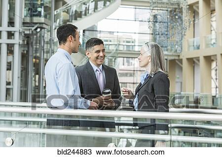 Business people talking in lobby View Large Photo Image Stock Image - Business people talking in lobby. Fotosearch