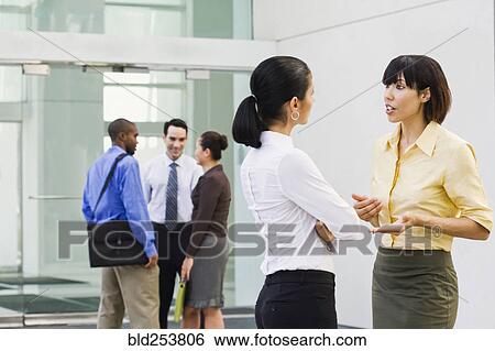 Business people talking in lobby View Large Photo Image Stock Photograph - Business people talking in lobby. Fotosearch