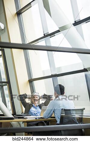 Picture - Business people talking in meeting. Fotosearch