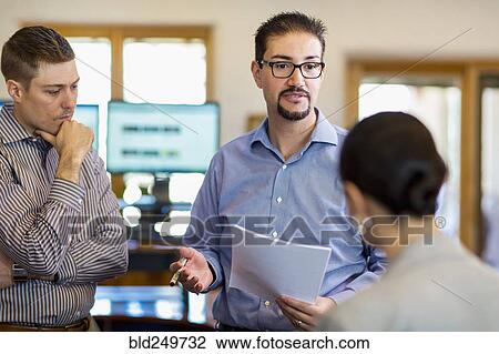 Stock Image - Business people talking in office. Fotosearch