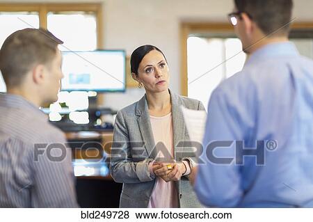 Stock Photo - Business people talking in office. Fotosearch