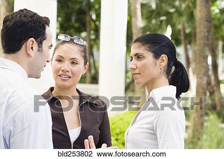 Stock Image - Business people talking outdoors. Fotosearch