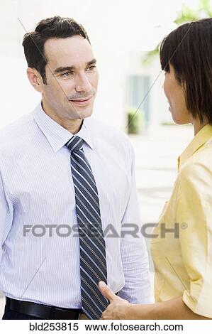 Stock Photography - Business people talking outdoors. Fotosearch