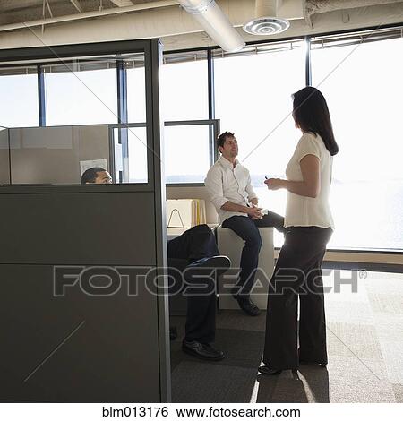 Stock Photograph - Business people talking together in office. Fotosearch