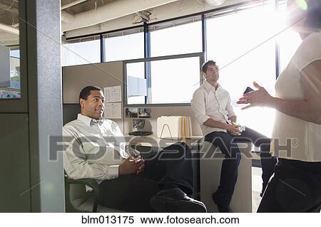 Stock Photography - Business people talking together in office. Fotosearch
