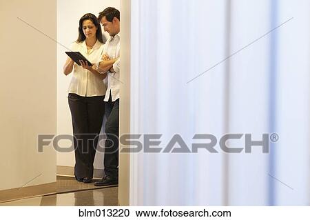 Business people using digital tablet in office View Large Photo Image Stock Image - Business people using digital tablet in office. Fotosearch