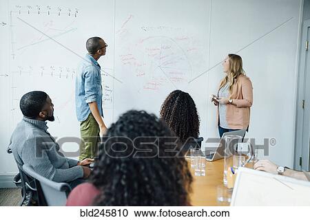 Business people using whiteboard in meeting View Large Photo Image Stock Image - Business people using whiteboard in meeting. Fotosearch