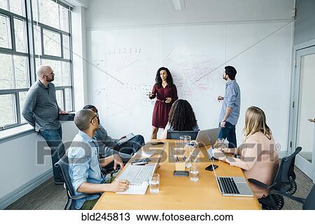 Business people using whiteboard in meeting View Large Photo Image Stock Image - Business people using whiteboard in meeting. Fotosearch