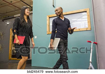 Stock Photo - Business people walking and talking. Fotosearch