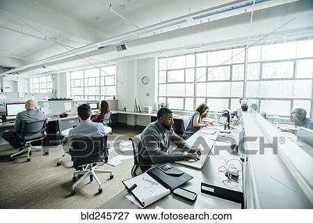 Business people working in busy office View Large Photo Image Stock Photo - Business people working in busy office. Fotosearch