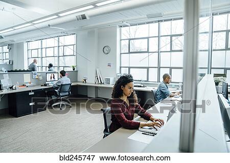 Business people working in busy office View Large Photo Image Stock Photo - Business people working in busy office. Fotosearch