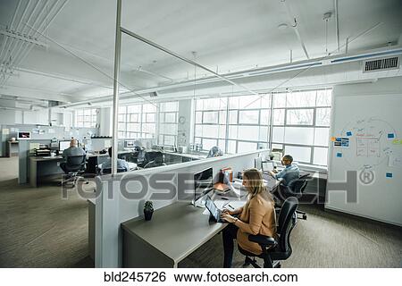 Business people working in busy office View Large Photo Image Stock Photograph - Business people working in busy office. Fotosearch