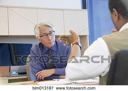 Business people working together in office View Large Photo Image Stock Photo - Business people working together in office. Fotosearch