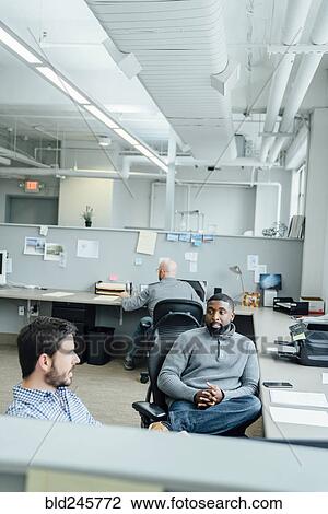 Businessmen talking in office View Large Photo Image Stock Image - Businessmen talking in office. Fotosearch