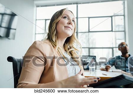 Businesswoman listening in meeting View Large Photo Image Stock Image - Businesswoman listening in meeting. Fotosearch