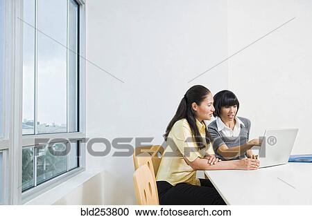 Businesswomen using laptop View Large Photo Image Stock Image - Businesswomen using laptop. Fotosearch