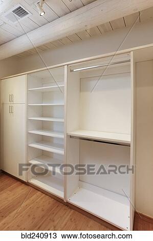 Cabinets and empty shelves in walk-in closet View Large Photo Image Stock Image - Cabinets and empty shelves in walk-in closet. Fotosearch