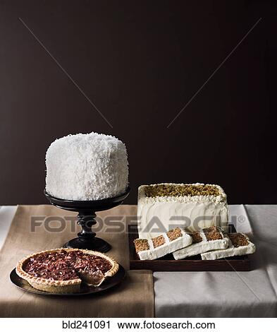 Stock Image - Cakes and pie on table. Fotosearch