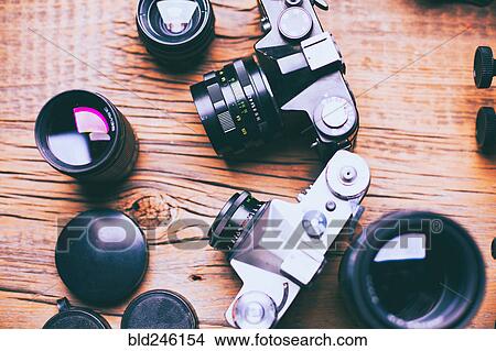 Cameras and lenses on wooden table View Large Photo Image Picture - Cameras and lenses on wooden table. Fotosearch