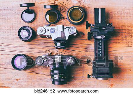 Cameras and lenses on wooden table View Large Photo Image Stock Image - Cameras and lenses on wooden table. Fotosearch