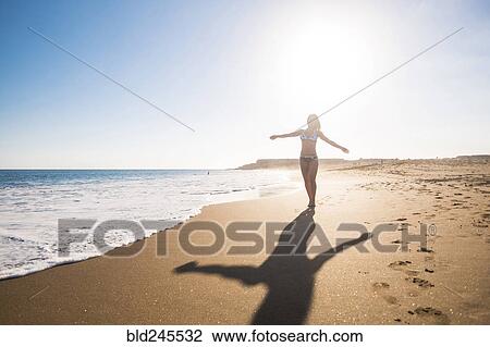 Carefree Caucasian woman walking on beach View Large Photo Image Stock Image - Carefree Caucasian woman walking on beach. Fotosearch