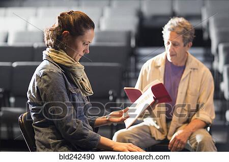 Caucasian actors rehearsing with scripts in theater View Large Photo Image Stock Image - Caucasian actors rehearsing with scripts in theater. Fotosearch