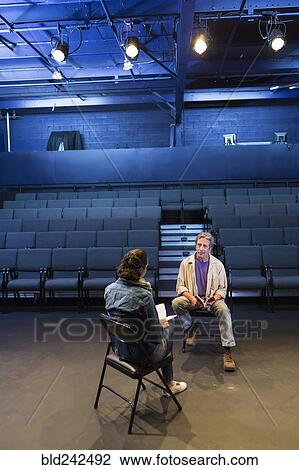 Caucasian actors rehearsing with scripts in theater View Large Photo Image Stock Image - Caucasian actors rehearsing with scripts in theater. Fotosearch
