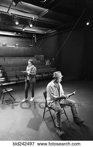 Caucasian actors rehearsing with scripts in theater View Large Photo Image Stock Photo - Caucasian actors rehearsing with scripts in theater. Fotosearch