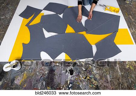 Caucasian artist arranging pieces of painting View Large Photo Image Stock Image - Caucasian artist arranging pieces of painting. Fotosearch
