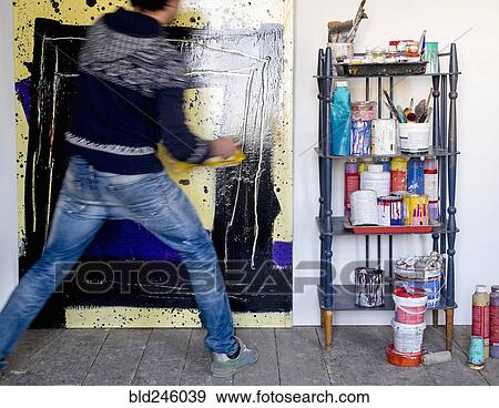Caucasian artist holding painting with pain roller View Large Photo Image Stock Photo - Caucasian artist holding painting with pain roller. Fotosearch