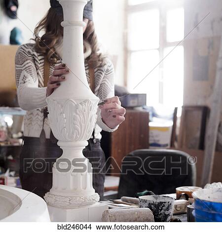 Picture - Caucasian artist sculpting with tool. Fotosearch