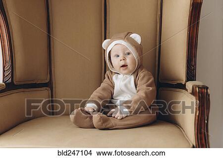 Caucasian baby boy sitting in armchair wearing bear costume View Large Photo Image Picture - Caucasian baby boy sitting in armchair wearing bear costume. Fotosearch