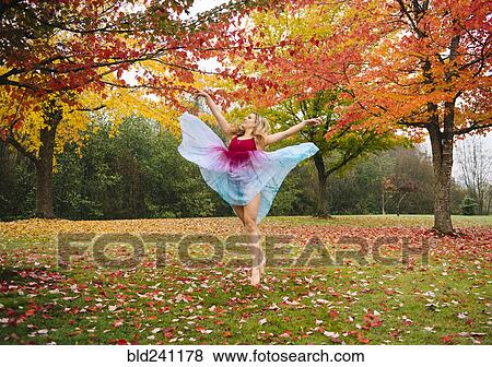 Caucasian ballerina dancing in autumn leaves in park View Large Photo Image Stock Photo - Caucasian ballerina dancing in autumn leaves in park. Fotosearch