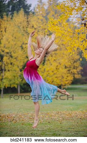 Caucasian ballerina dancing in park View Large Photo Image Stock Image - Caucasian ballerina dancing in park. Fotosearch