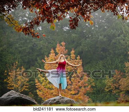 Caucasian ballerina dancing on rock in park View Large Photo Image Stock Image - Caucasian ballerina dancing on rock in park. Fotosearch