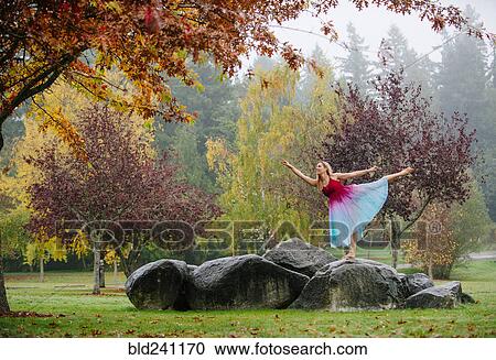 Caucasian ballerina dancing on rocks in park View Large Photo Image Stock Image - Caucasian ballerina dancing on rocks in park. Fotosearch