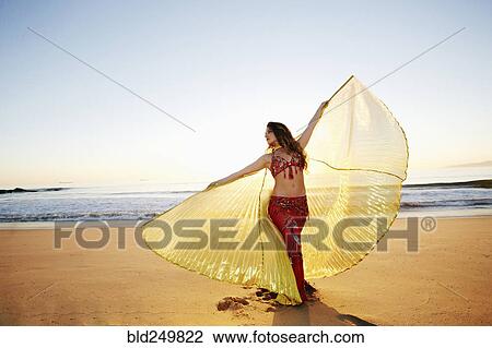 Caucasian belly dancer holding cape on beach View Large Photo Image Stock Image - Caucasian belly dancer holding cape on beach. Fotosearch