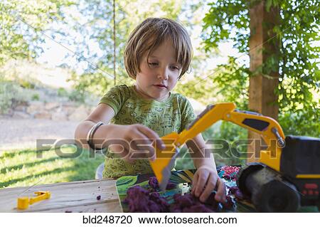 Caucasian boy playing with construction toy View Large Photo Image Stock Image - Caucasian boy playing with construction toy. Fotosearch