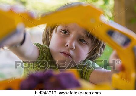 Caucasian boy playing with construction toilet View Large Photo Image Stock Photo - Caucasian boy playing with construction toilet. Fotosearch