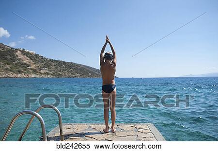 Caucasian boy preparing to swim in lake View Large Photo Image Stock Photography - Caucasian boy preparing to swim in lake. Fotosearch